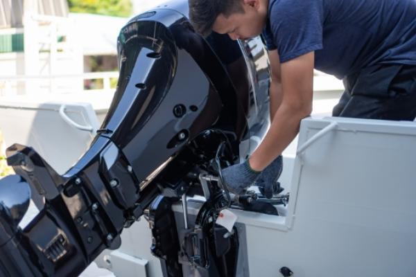 Marine mechanic servicing boat at Gordon Bay Marine