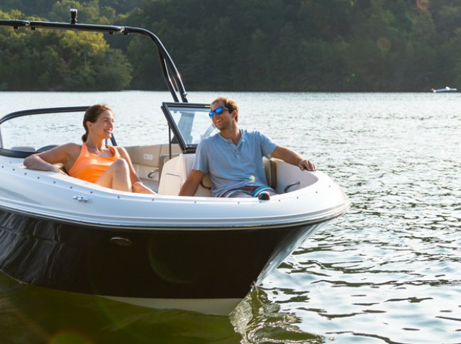 A couple in their Bayliner BR4 on the water in Muskoka near Toronto Ontario